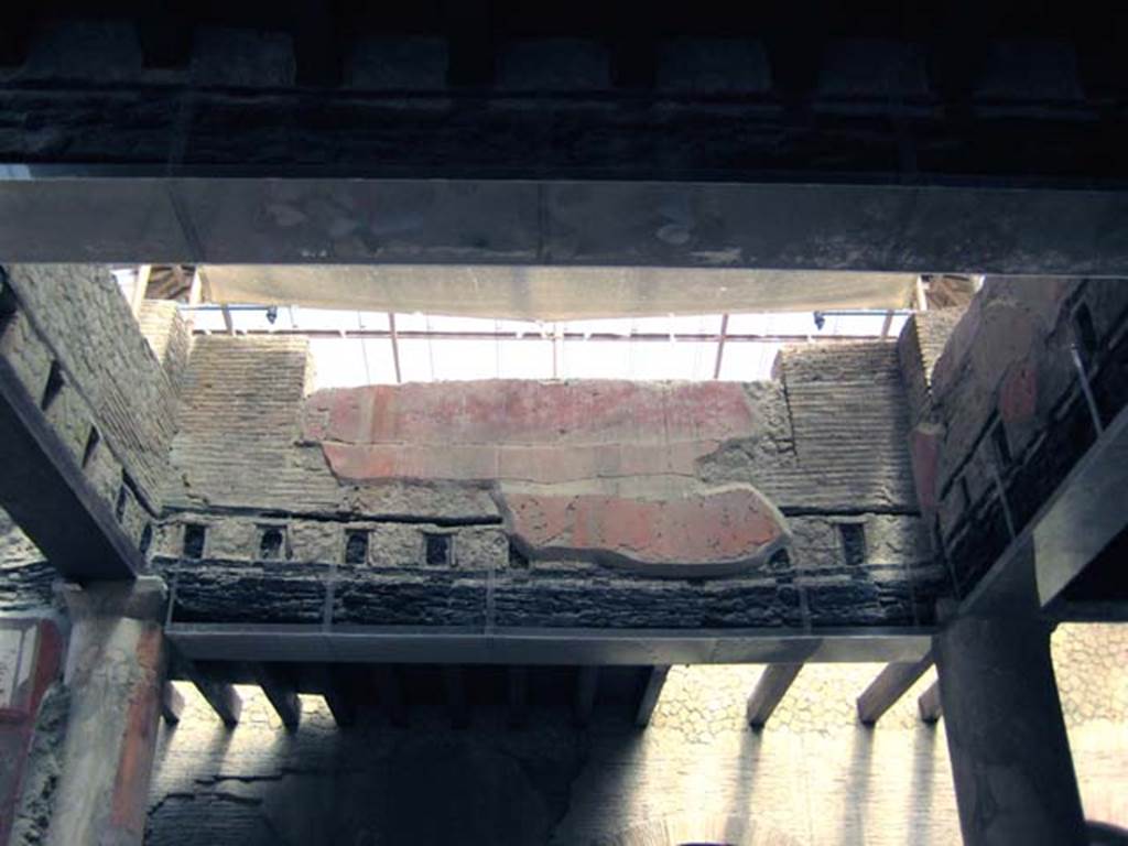 VI.21 Herculaneum. June 2011. Looking west towards area with reconstructed modern floor beams of upper floor.
Photo courtesy of Sera Baker.
